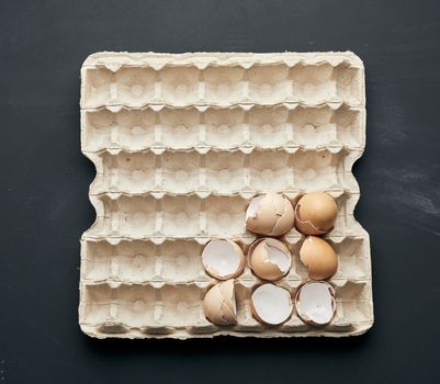eggshell in a paper tray on a black wooden table