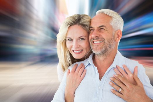 Composite image of smiling couple embracing with woman looking at camera