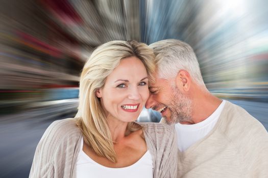 Composite image of happy couple laughing together woman looking at camera