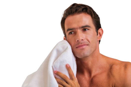 Cutout of attractive man wiping his face with towel in bathroom
