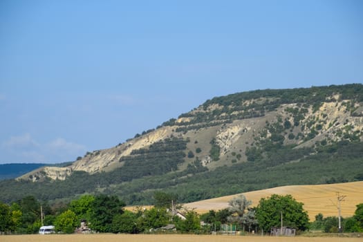 Landscapes of Crimean nature. Fields and hills visible from the car window from the road.
