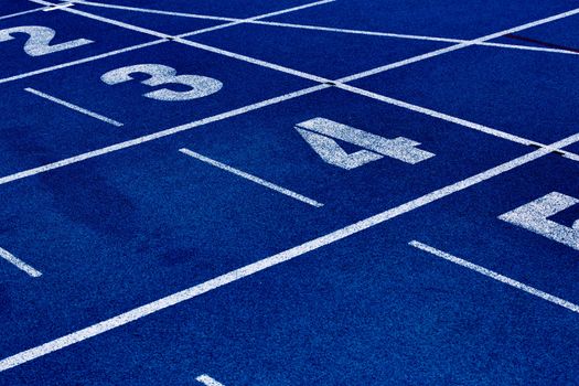 Close up of 400 meter sprint blue tracking field