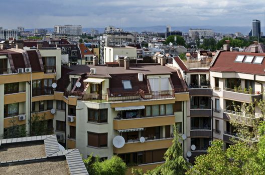 Residential neighborhood with new modern houses against the backdrop of a cityscape in the Bulgarian capital Sofia