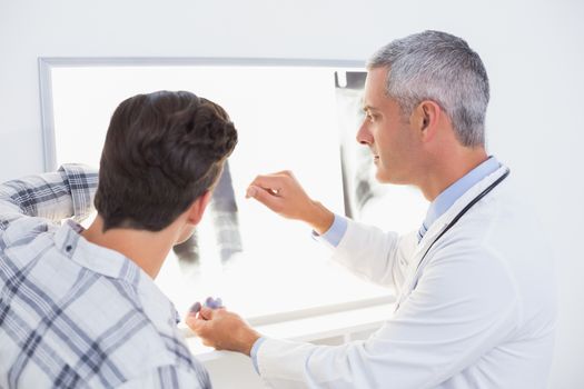 Doctor looking X rays with his patient 