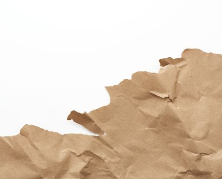 fragment of a crumpled blank sheet of brown wrapping kraft paper
