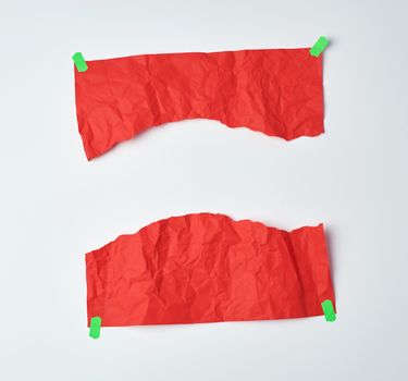 crumpled red sheet of A4 paper torn in half and glued with green