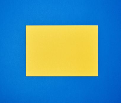 blank yellow sheet of A4 paper on a blue background