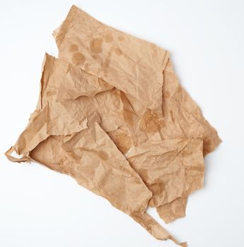 torn crumpled pieces of brown paper with grease stains 