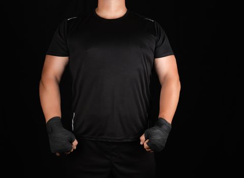 adult athlete in black uniform is standing in a rack with strain