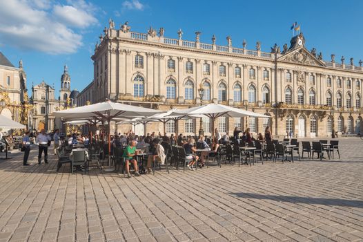 Nancy, France - 20 June 2018: Café Terrace in the Place Stanislas square at sunset.