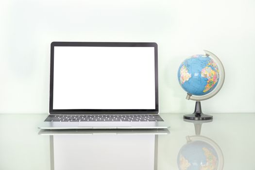 Laptop mockup with blank screen and simulated world on table