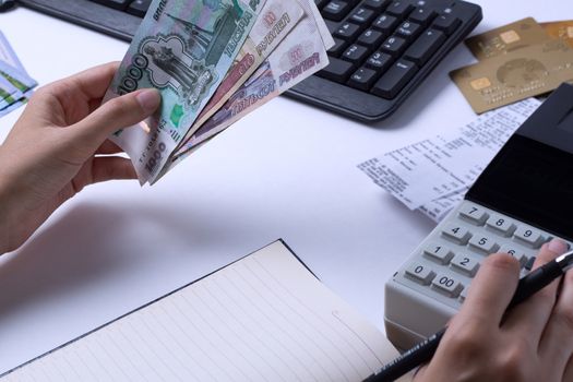 The issue of wages in Russia. Accountant cashier counts the mone