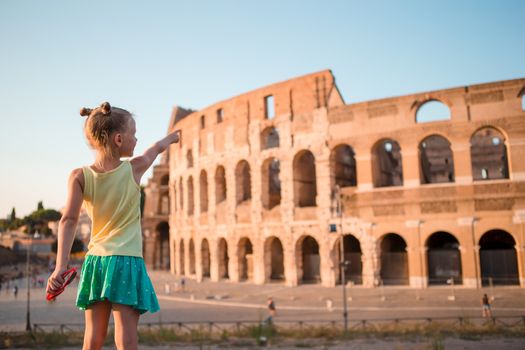 Young girl in front of Colosseum in rome, italy