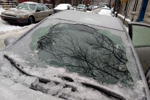 Thick layer of ice covering car after freezing rain in Montreal,