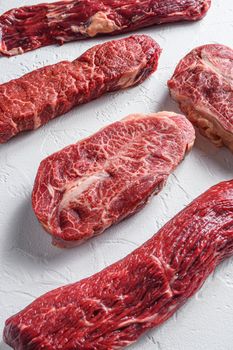 Set of denver, top blade, tri tip steak, machete, flank, bavette London broil marble beef on white background side view close up
