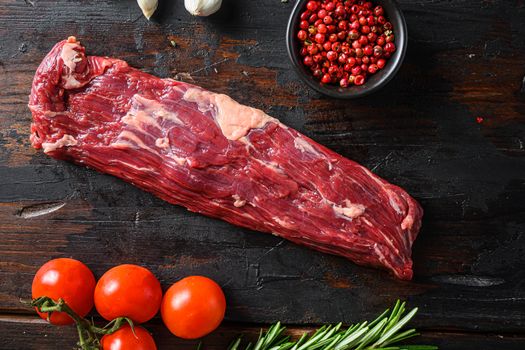 Machete steak raw alternative beef cut or hanging tende cut, with rosemary over wood background Top side view