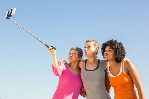 Sporty women posing and taking selfies with selfiestick 