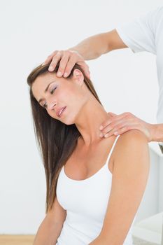 Male chiropractor doing neck adjustment