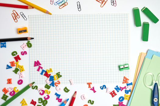 school supplies: multicolored wooden pencils,  notebook, colored