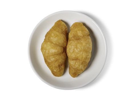 Fresh croissant on plate with clipping path isolated on a white 