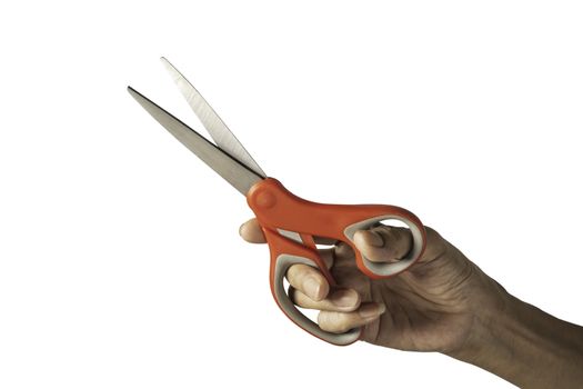 Hand holding a scissors with red plastic handle and clipping pat