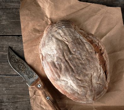 baked crisp oval bread and vintage knife