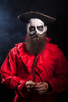 Dangerous pirate with black beard over black background