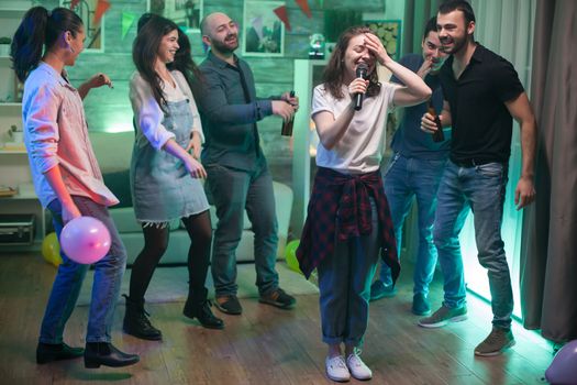 Young woman can't believe she's doing karaoke