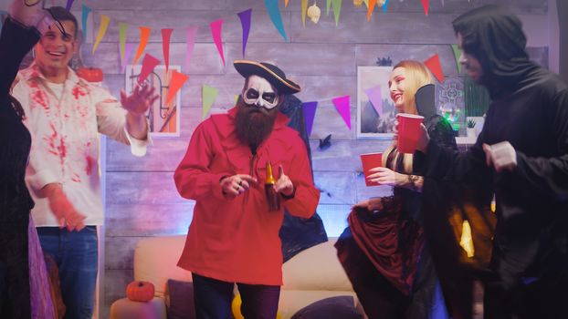 Man dressed up like a pirate dancing with people dressed up like different monsters