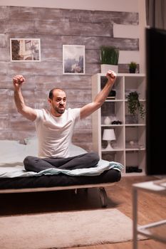 Excited man in bedroom