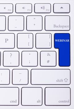Keyboard with webinar text on blue button