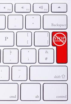 Red button on keyboard with stop terrorism word on it