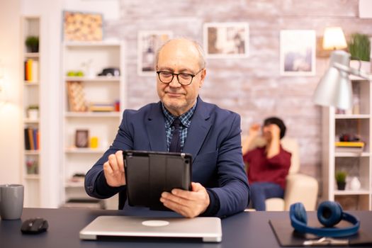Senior man in his 60s using a modern digital tablet