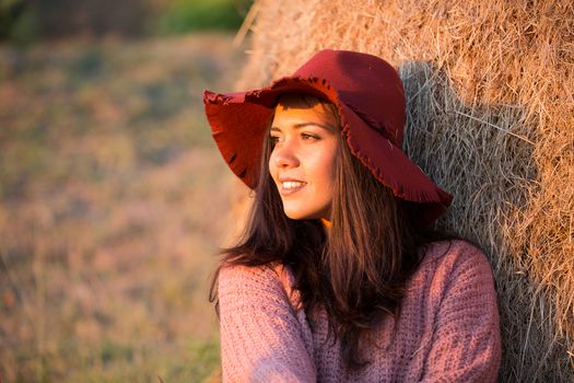 Side view portrait of beautiful young woman with stylish hat