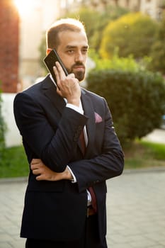 Concentrated businessman talking on the phone in the street