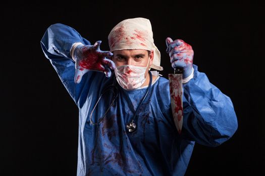 Doctor covered in blood with mask on his face for halloween in s
