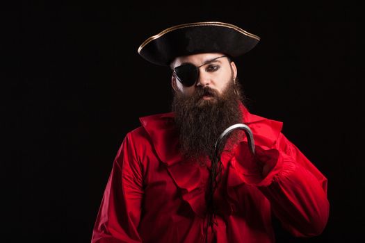 Portrait of handsome bearded man wearing medieval pirate clothes