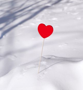 red heart sticks out of a white snowdrift