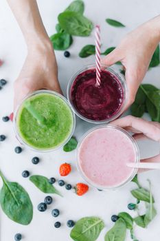 Row of healthy fresh fruit and vegetable smoothies with assorted ingredients