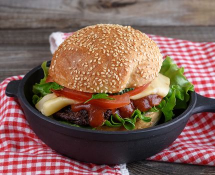 burger with a meatball and vegetables 