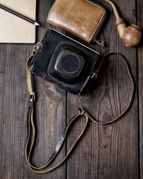 old vintage camera in a case on a wooden background