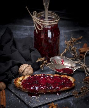 white bread toast spread with raspberry jam