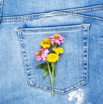 bouquet of flowers on the back pocket of blue jeans