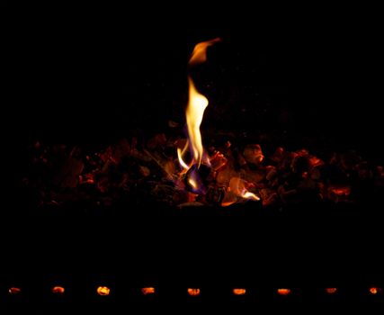 Smoldering coals and fire on a black background
