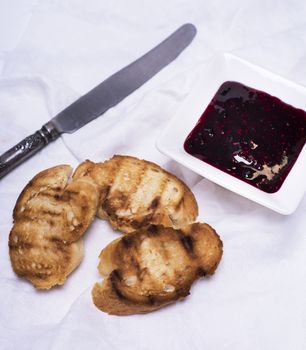 fried pieces of white bread and raspberry jam 