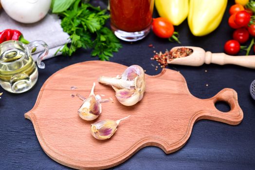 Garlic in a husk on a wooden kitchen board