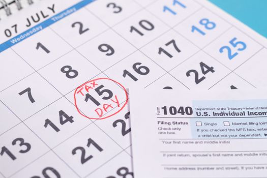 July 15th marked as tax day on calendar with Tax from - Concept of file tax form before deadline july 15th