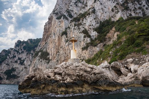 Beacon on rocks at the entrance of Capri port