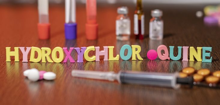 hydroxychloroquine or HCQ drug in colourful letters on table used for malaria.