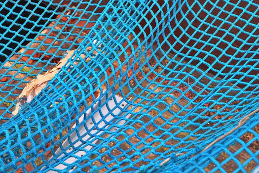 Close up on a blue fishing net at the harbour of Kiel in Germany